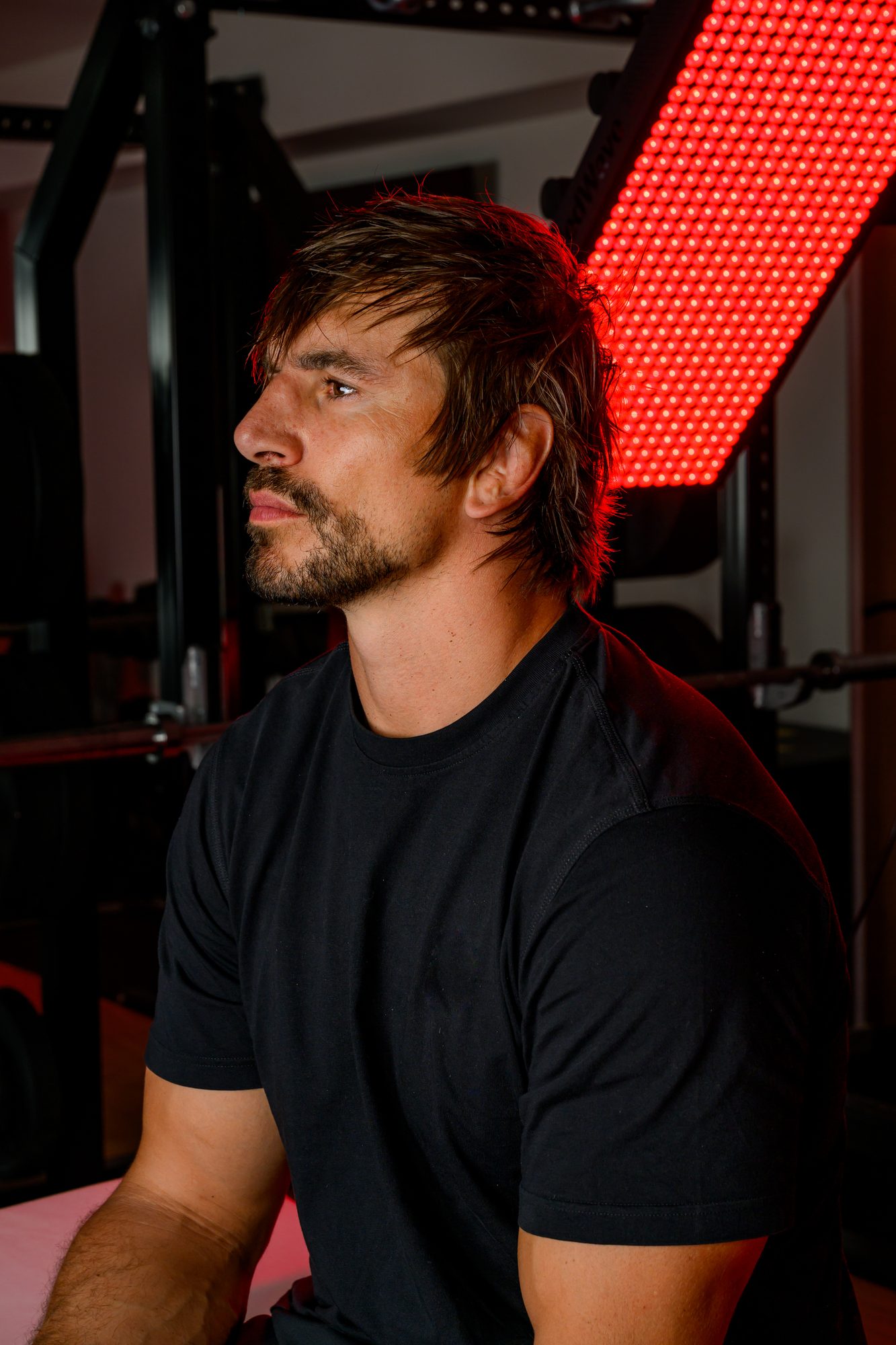 Eben Etzebeth in profile beside the glowing Optimum-100S LED array